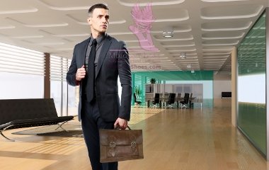 Confident businessman with bag looking away